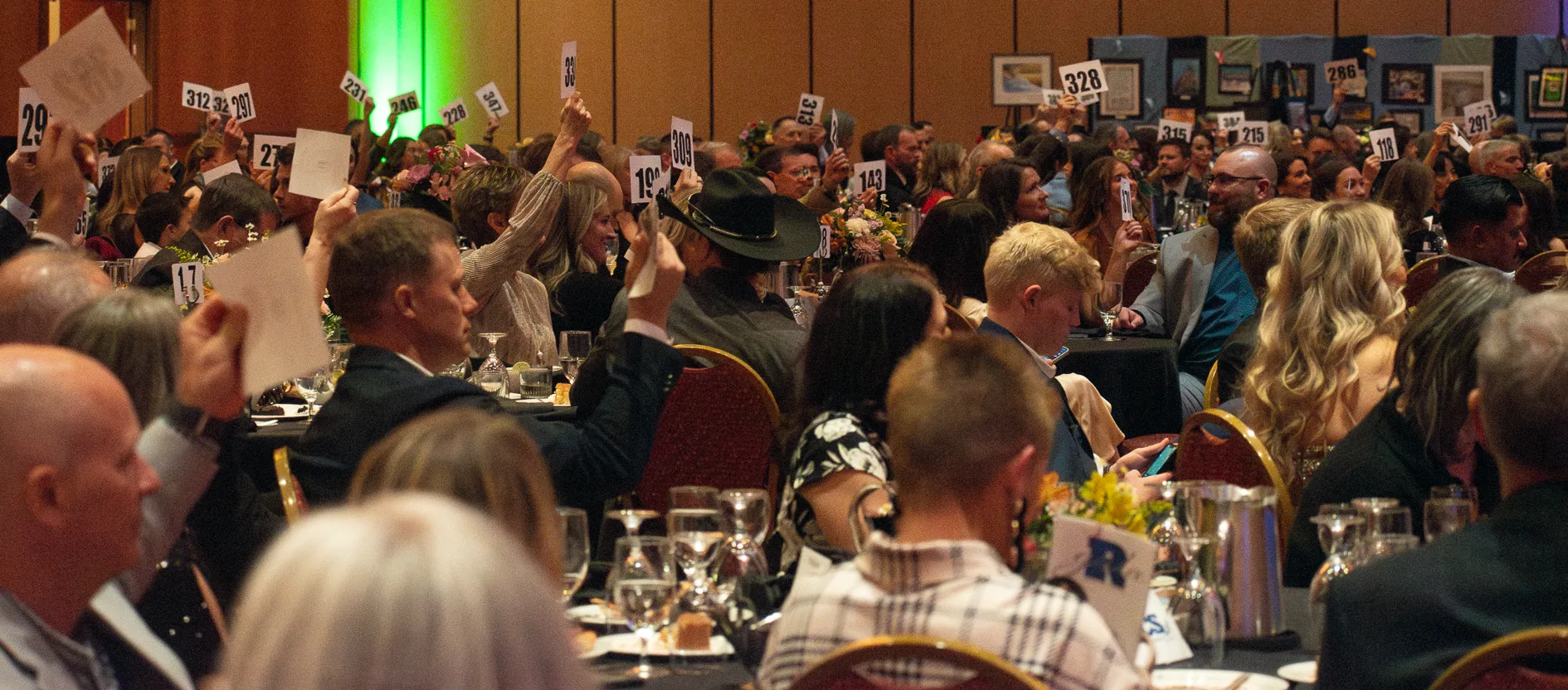 Promotional graphic for a 2026 Cougar Gala featuring a suited professional quarterback and a staged seating area for Resurrection Christian School.